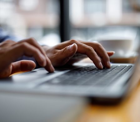 close up photo of someone using a laptop keyboard